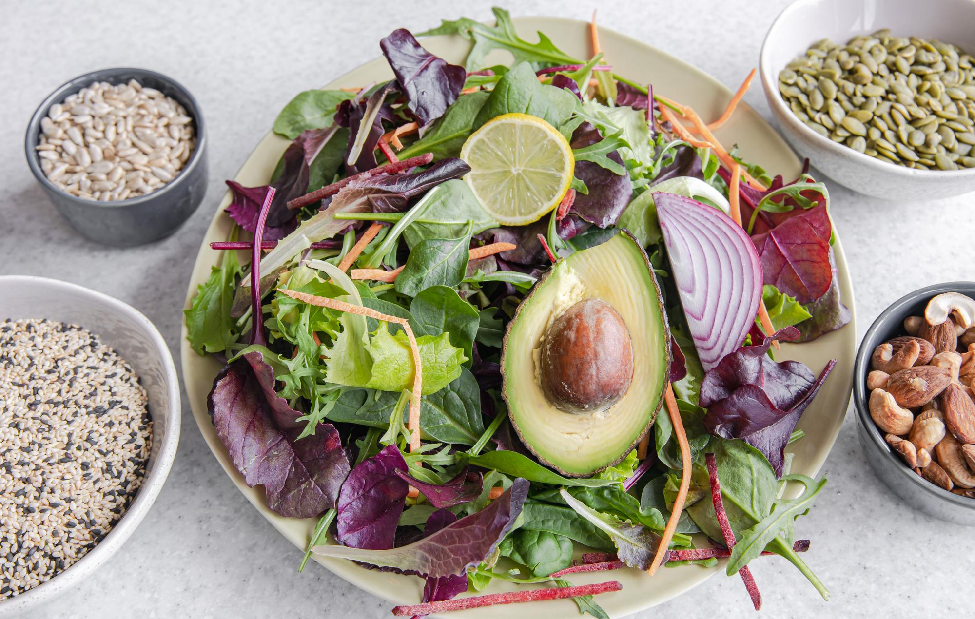 Colourful seasonal grain bowl with vegetables and herbs